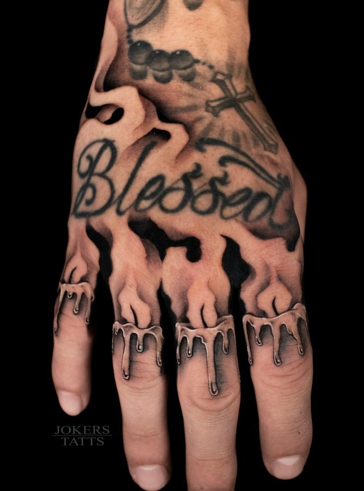 a man's hand with tattoos on it and the words blessing written in black ink