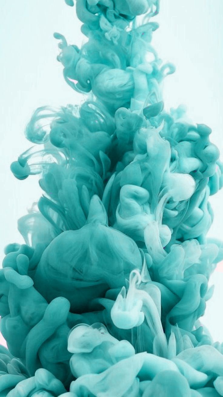 blue ink is being mixed in with the water to create an unusual shape and color