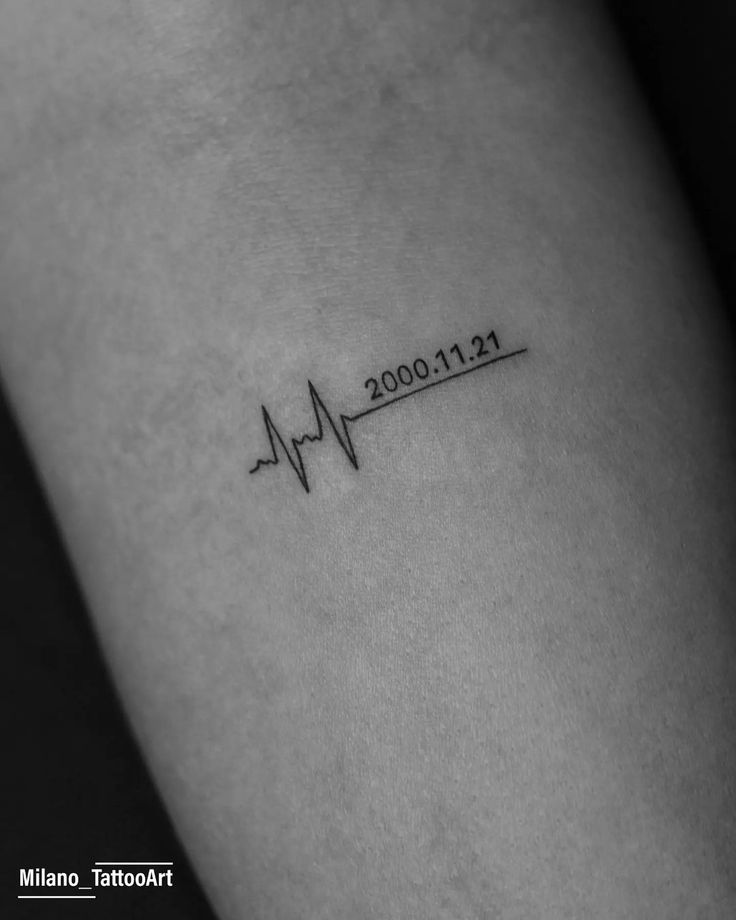 a small heartbeat tattoo on the arm