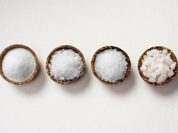 three small bowls filled with sugar next to each other on top of a white surface