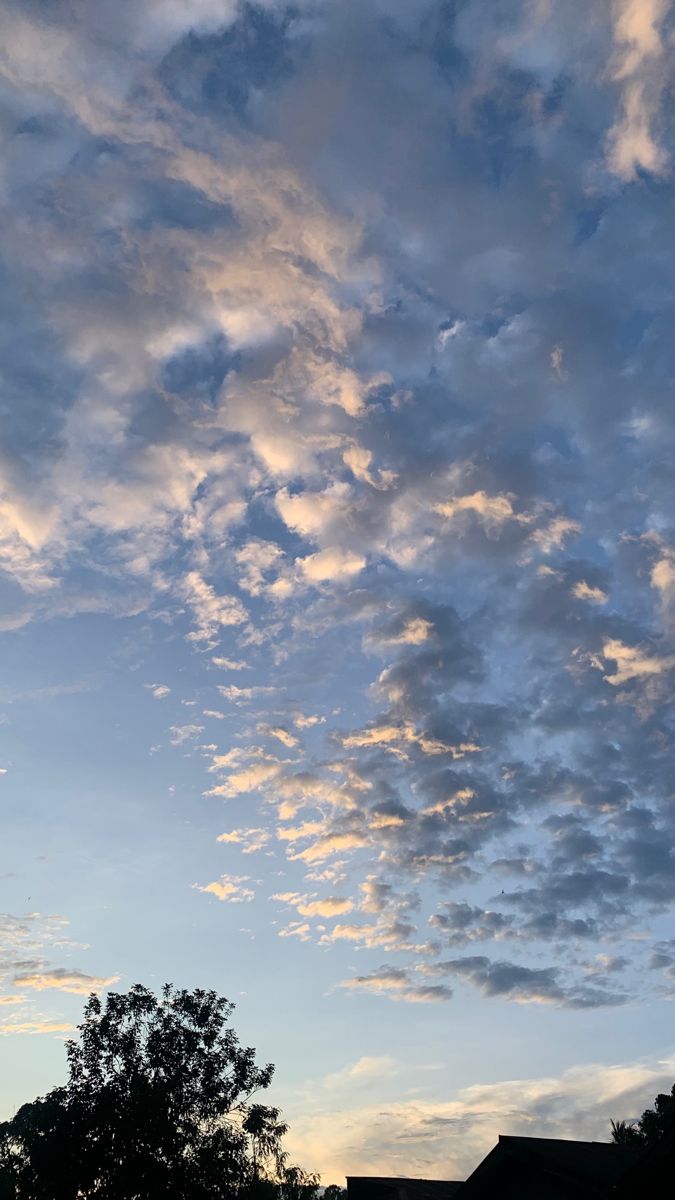 the sky is filled with clouds and trees