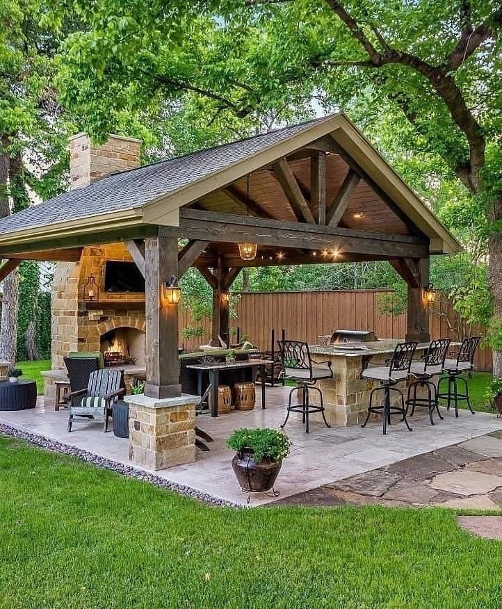 an outdoor kitchen and grill area in the backyard