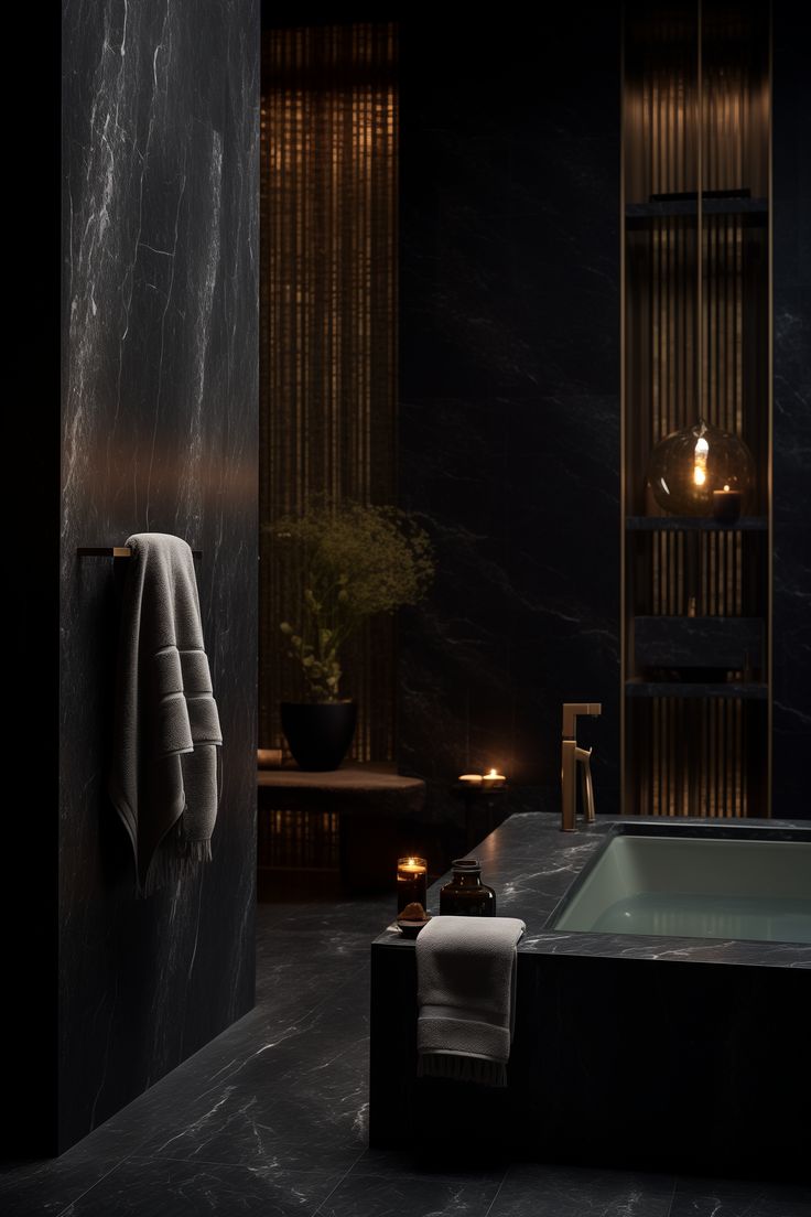 a bath tub sitting next to a wooden shelf filled with towels and candles in a dark bathroom