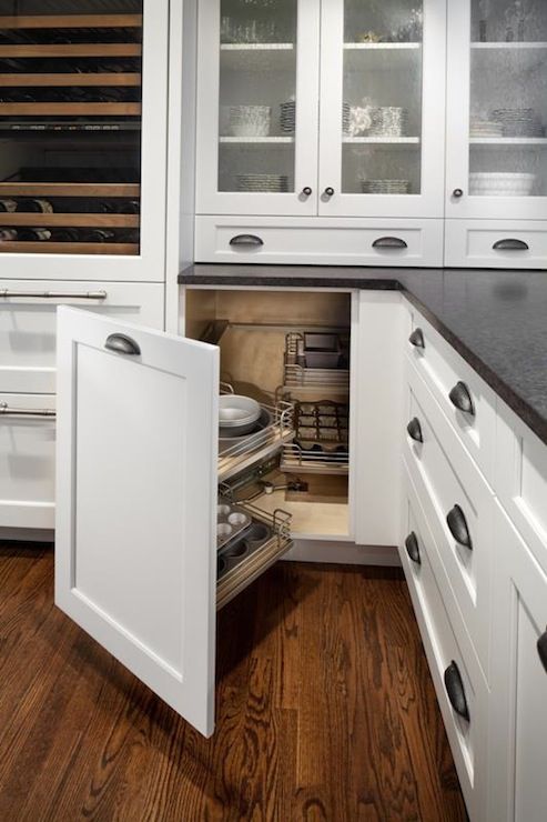 an open cabinet in the middle of a kitchen