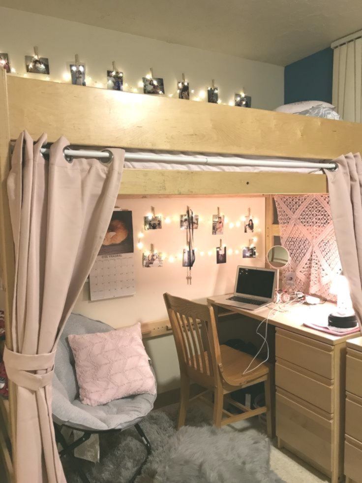 a loft bed with a desk and chair underneath it