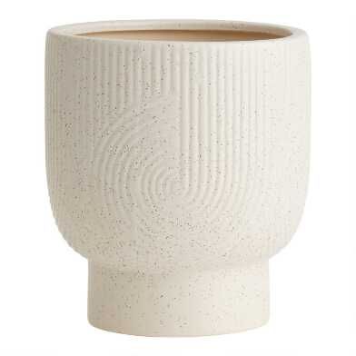 a white ceramic cup sitting on top of a table