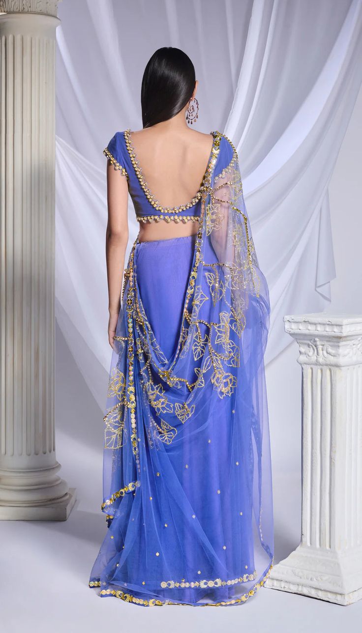 Crafted with meticulous detailing, this deep blue organza saree is richly adorned with metallic accents, crystals, and sequins forming floral patterns while the pre-stitched tulle bottom features delicate scattered embroidery. Complementing the ensemble, the blue georgette blouse is detailed with metal circles, pearls embroidery, and intricate cutwork.From Papa Don’t Preach’s Bring Your Own Fairytale collection. DELIVERY TIMEPlease allow 8-12 weeks for your outfit to arrive. FABRIC DETAILSTulle Engagement Sarees, Blue Sari, Papa Don't Preach, Reception Sarees, Haldi Dress, Tulle Embroidery, Blue Organza, Bridal Jumpsuit, Drape Saree