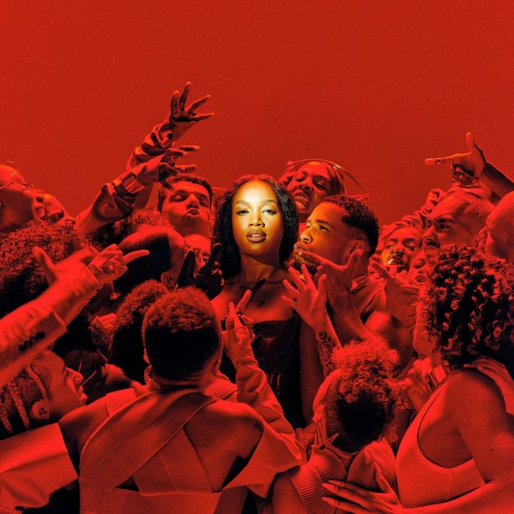 a group of people standing around each other in front of a red background with the woman's face partially obscured by her hands