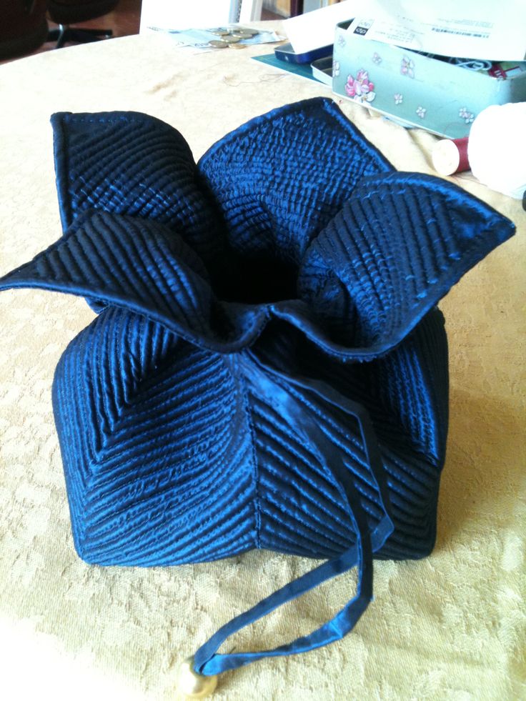 a large blue bow on top of a bed