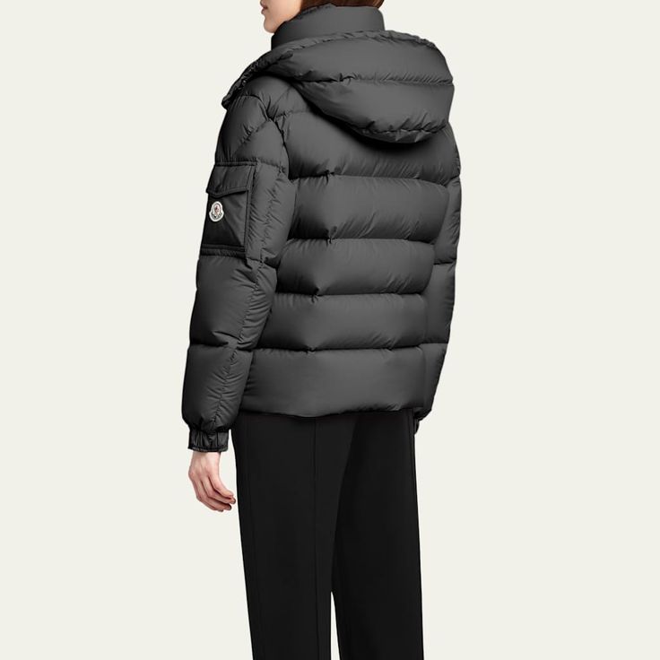 Moncler "Maya 70" puffer jacket crafted from matte nylon laqué with iconic boudin quilting  Detachable hood with snap buttons; adjustable drawstring fastening Stand collar; two-way zipper/snap closure Long sleeves; adjustable, elasticized cuffs with snap buttons Flap pocket with logo patch at left sleeve Zipped external and internal pockets Hem with drawstring fastening  Polyester Lining: Nylon Fill: Down/Feather Hand wash Imported