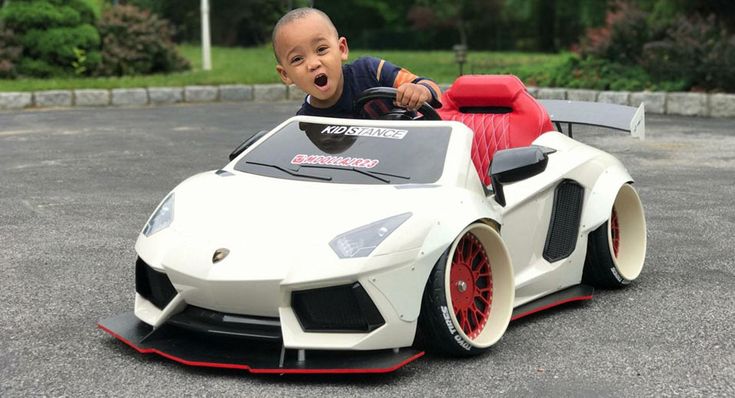 a baby in a toy car on the street