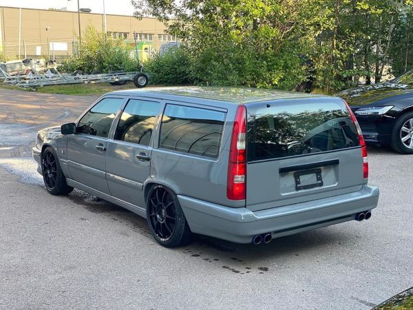 a grey station wagon parked in a parking lot