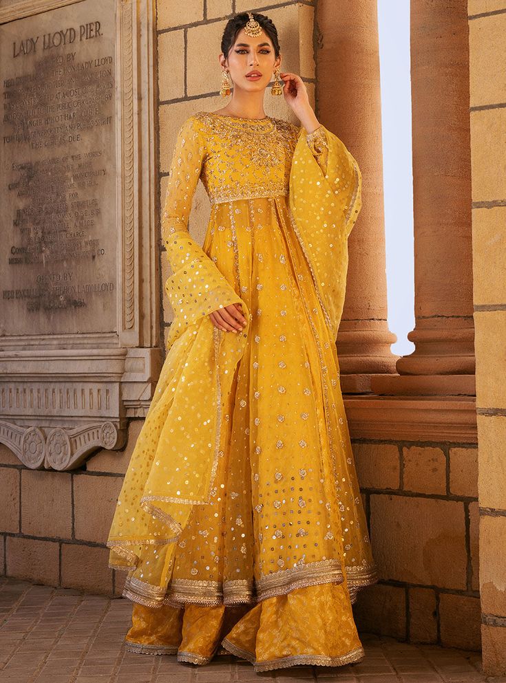 Safeeneh Semi-stitched Yellow Palazzo Set In Chanderi, Eid Anarkali Sharara With Mirror Work, Designer Sharara With Dupatta In Jamawar, Designer Jamawar Sharara With Dupatta, Yellow Chanderi Salwar Kameez With Mirror Work, Unstitched Jamawar Sharara With Mirror Work, Anarkali Sharara With Dabka Work For Festivals, Yellow Anarkali Palazzo Set For Eid, Designer Jamawar Sharara For Diwali