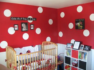 a baby's room decorated in red and white polka dots