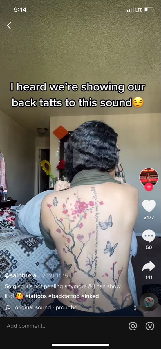 the back of a woman's body with tattoos on it and an image of flowers