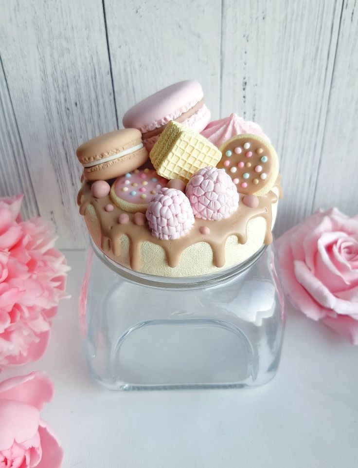 there is a cake with cookies and other things in it on top of a glass container