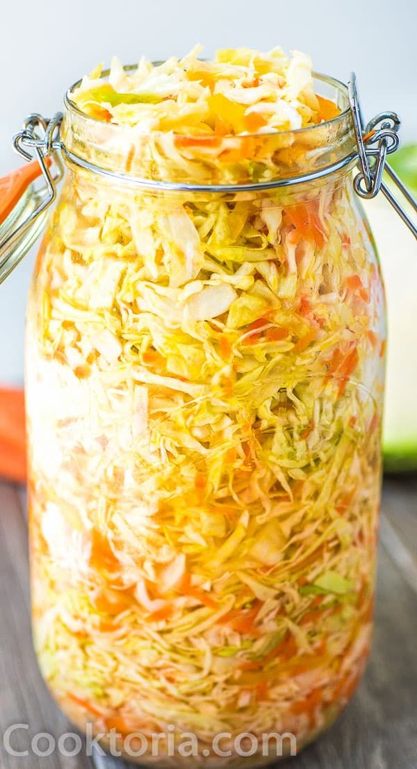 a jar filled with shredded carrots and cabbage