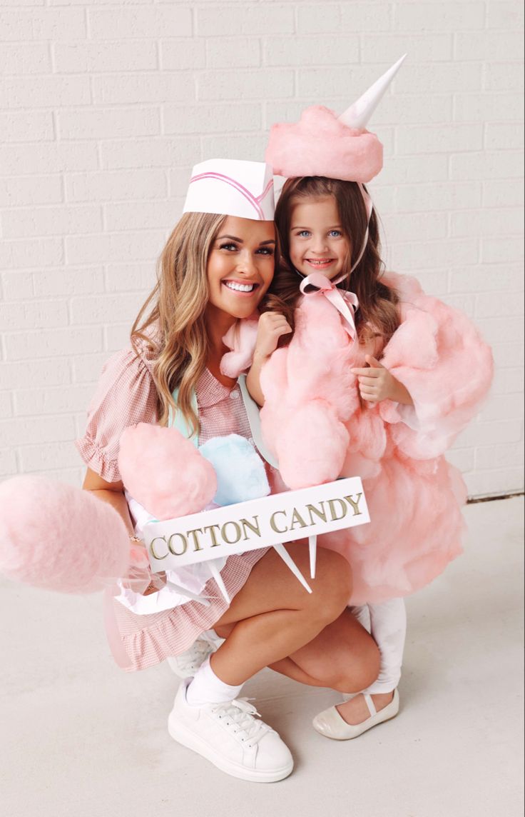 two girls dressed up as unicorns with cotton candy