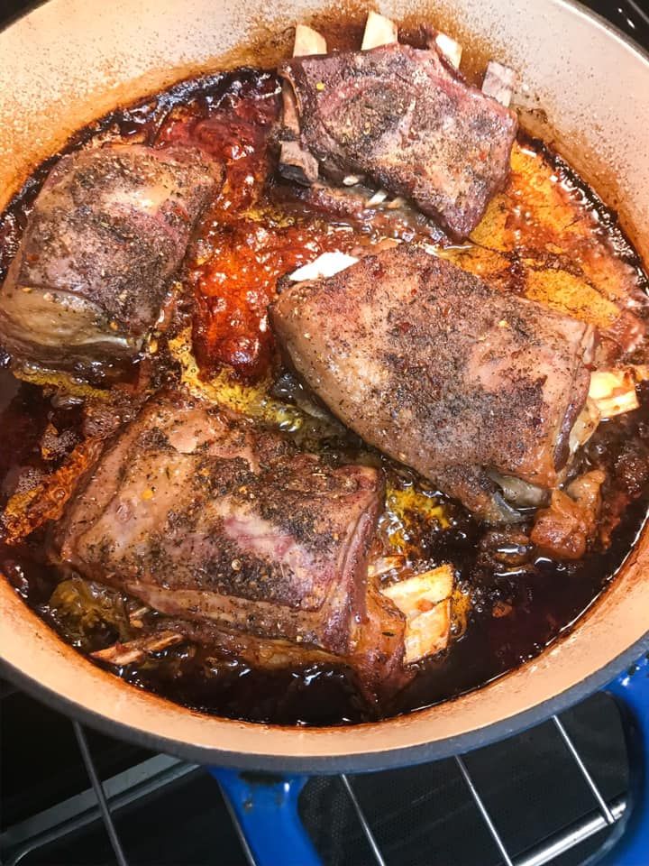 some meat is cooking in a pot on the stove