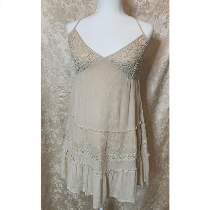 Tan Dress Beige Bohemian Mini Sundress, Beige Sundress With Lace Trim, Bohemian Beige Mini Dress For Day Out, Beige Mini Dress With Lace Trim For Vacation, Beige Mini Dress For Summer Brunch, Spring Taupe V-neck Dress, Beige Flowy Sundress Mini Dress, Cream Summer Mini Dress With Lace Trim, Beige Lace Trim Sundress