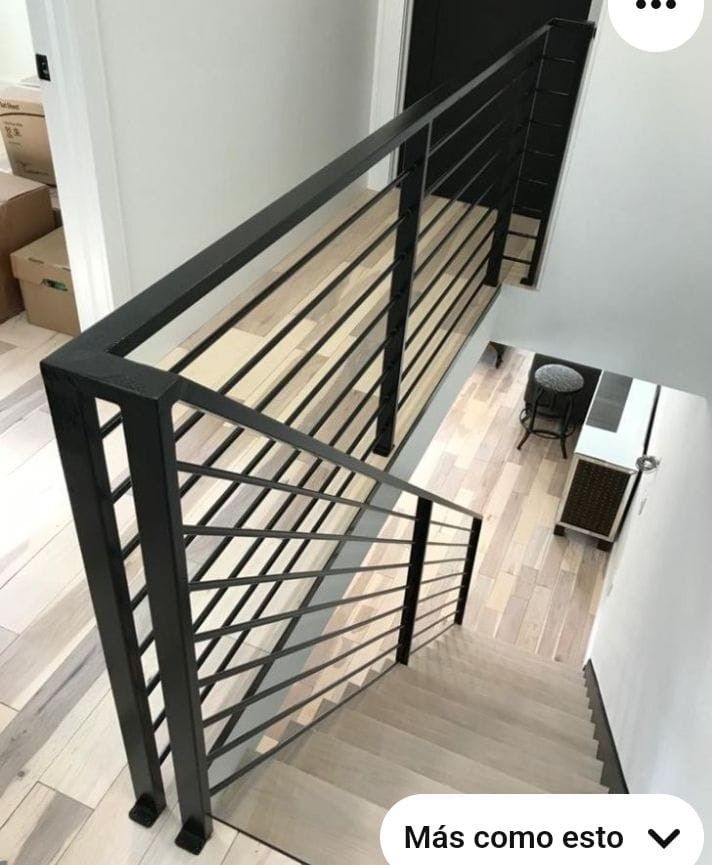 an overhead view of a stair case in a house with hardwood floors and white walls