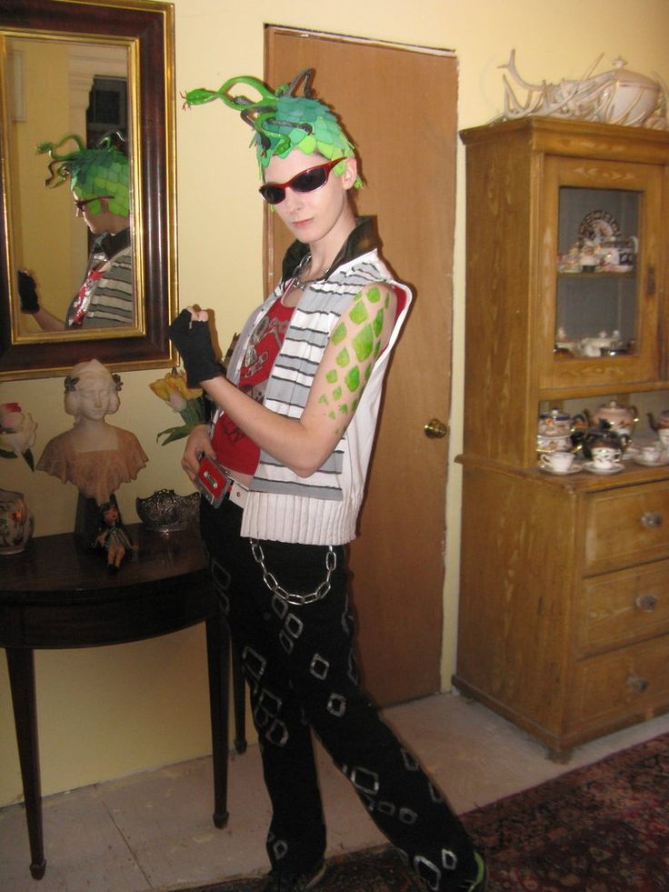 a woman dressed in costume standing next to a dresser