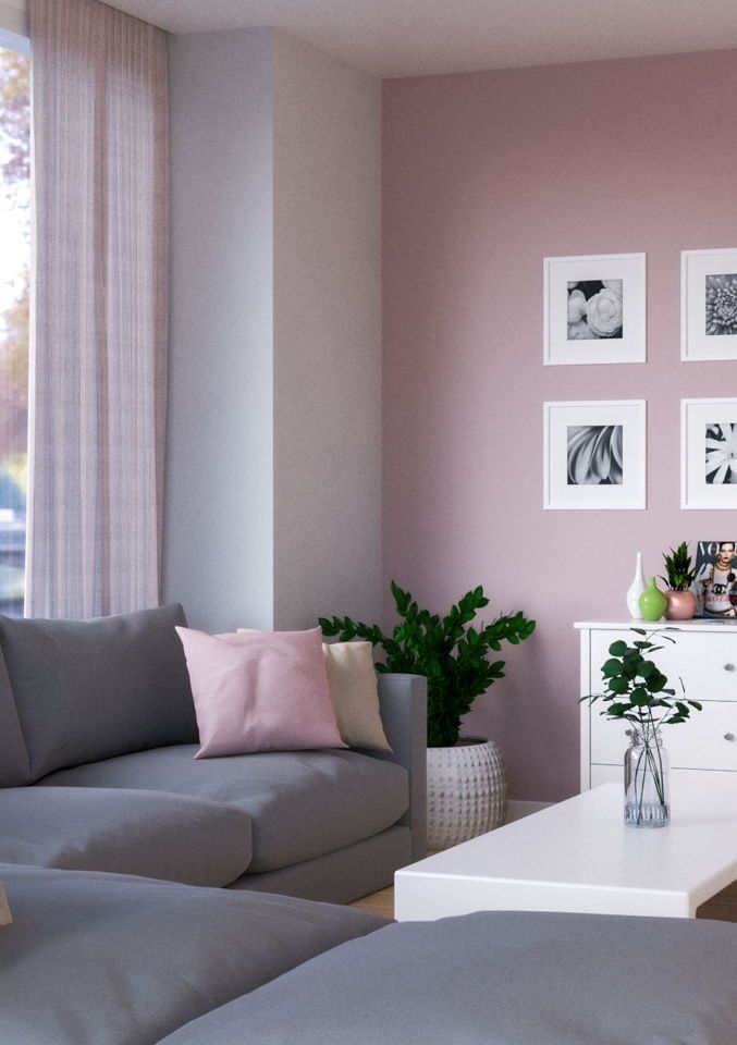 a living room filled with furniture and pictures on the wall next to a white coffee table