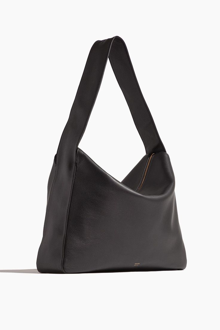 The Khaite Elena Large Shoulder Bag is a piece you'll have for years to come. This shoulder bag features a sleek silhouette with a classic zip top in pebbled leather. Shoulder bag Zip top Shoulder strap Length:17.5 in/44.5 cm Width:3.5 in/8.9 cm Height:14 in/35.6 cm Pebbled leather 100% Calfskin Sleek Textured Leather Bag For Everyday, Sleek Shoulder Bag With Top Handle And Smooth Grain, Sleek Top Handle Shoulder Bag With Smooth Grain, Everyday Structured Shoulder Bag With Smooth Grain, Sleek Double Handle Shoulder Bag With Smooth Grain, Minimalist Textured Leather Formal Bags, Formal Minimalist Textured Leather Bag, Everyday Leather Bag, Gorgeous Clothes