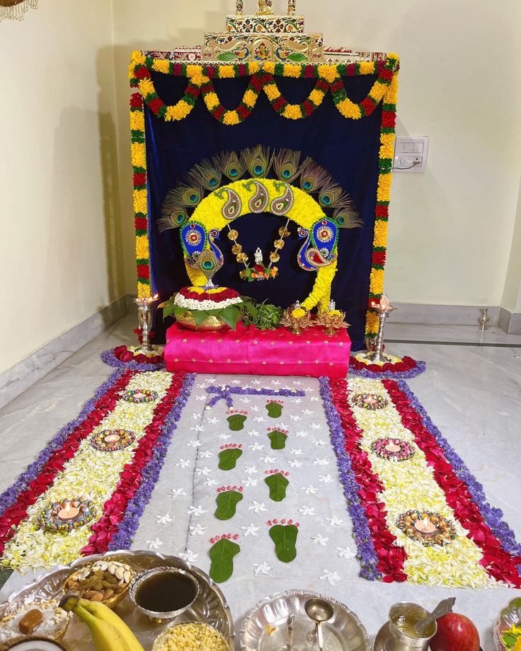 a decorated stage with food and decorations on the floor