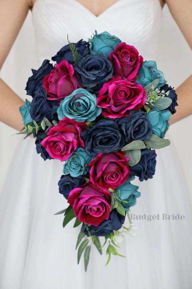 a bridal holding a bouquet of blue and pink flowers