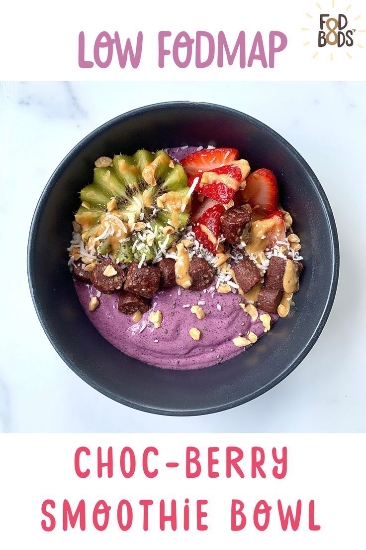 a bowl filled with fruit and nuts on top of a white table next to the words low fodmap choc - berry smoothie bowl