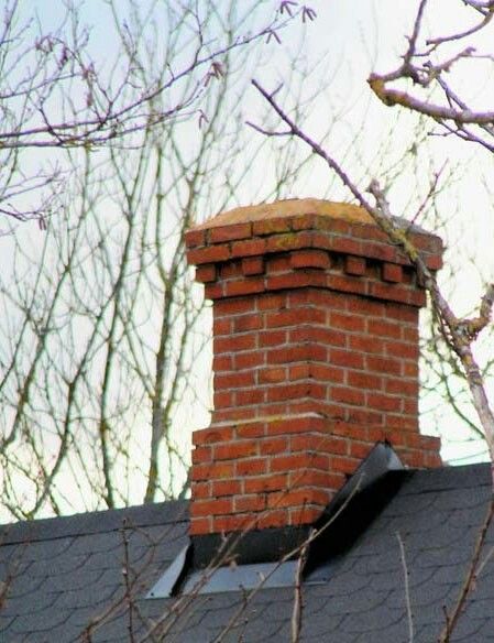 a brick chimney on the roof of a house