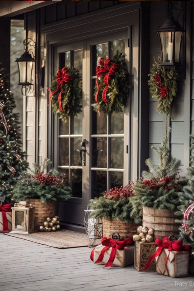 christmas decorations on the front porch of a house with holiday wreaths and presents in baskets