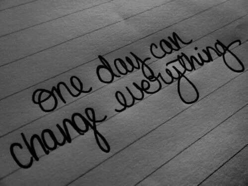 the words one day can change everything written in cursive writing on wood planks