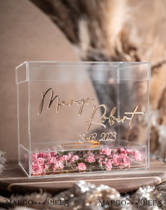 a clear acrylic box with pink flowers in it and the words happy bday