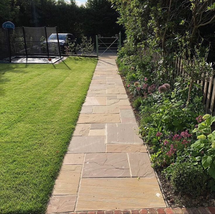 a stone path in the middle of a garden