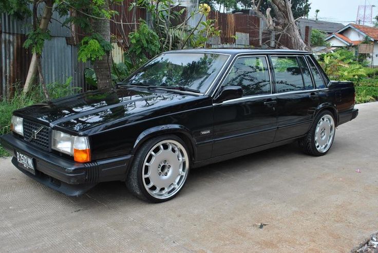 a black car parked in front of a house