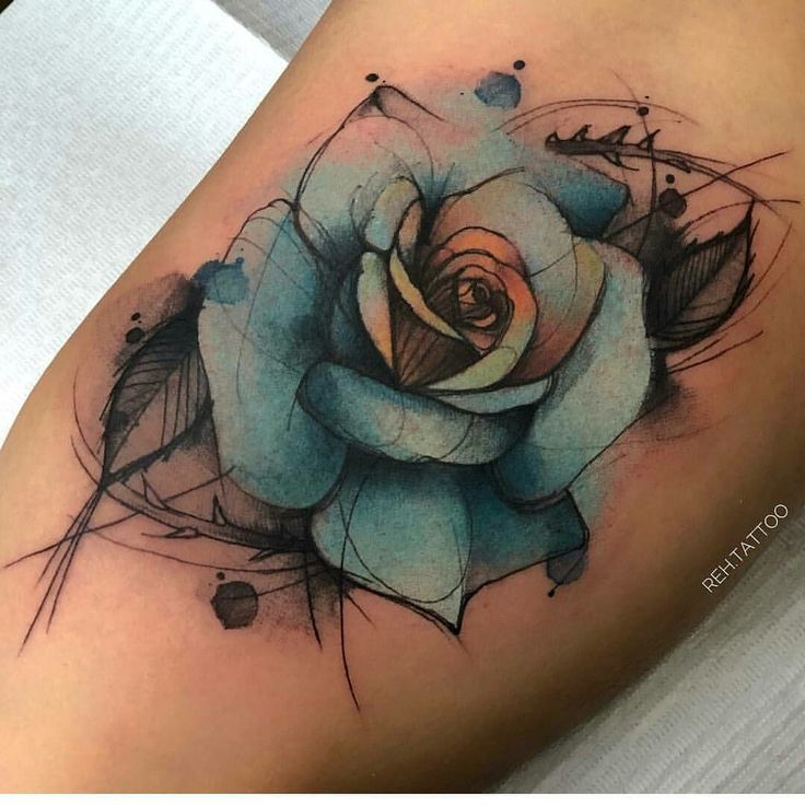 a blue rose tattoo on the thigh