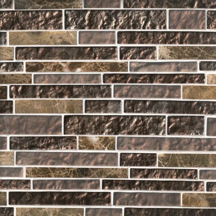 a close up view of a brick wall with brown and white tiles on the side