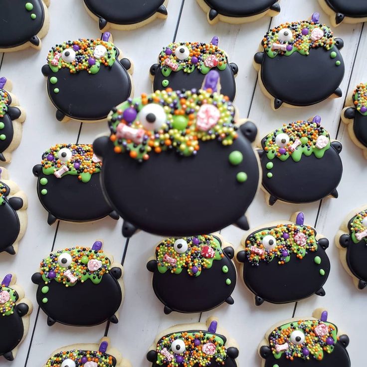 decorated cookies are arranged in the shape of witches