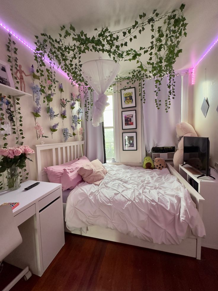 a bedroom decorated in pink and white with plants growing on the wall above the bed