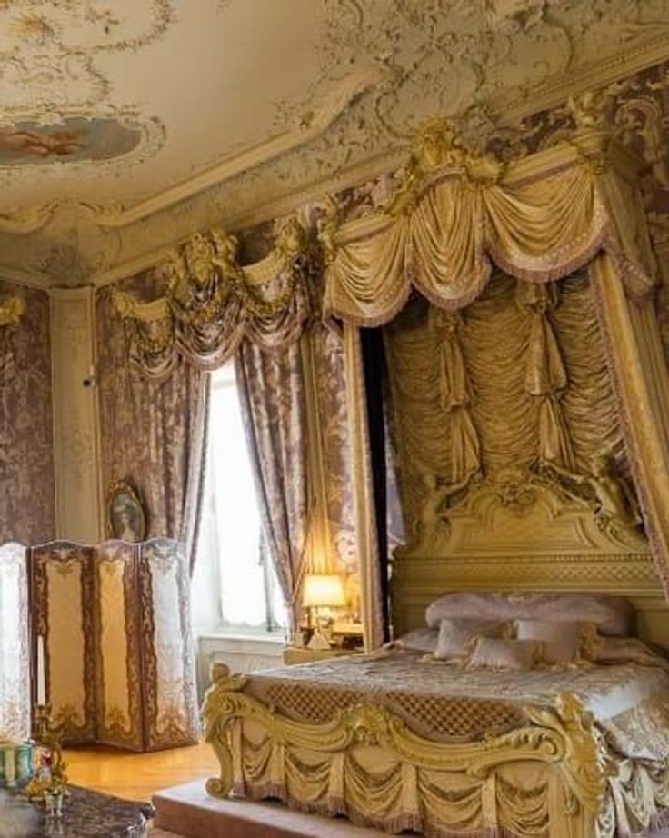 an ornate bedroom with gold and white decor on the walls, ceiling and bedding