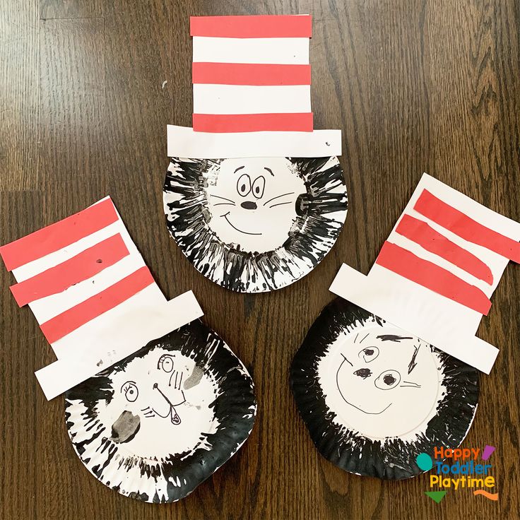 three paper plates with cat in the hat faces on them, one is made out of construction paper