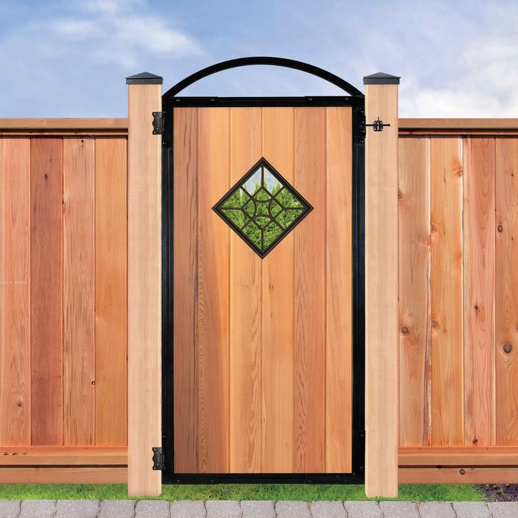 a wooden fence with an ornamental gate