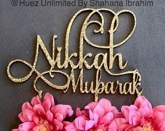 there is a cake topper that says nikkah mubarak on it