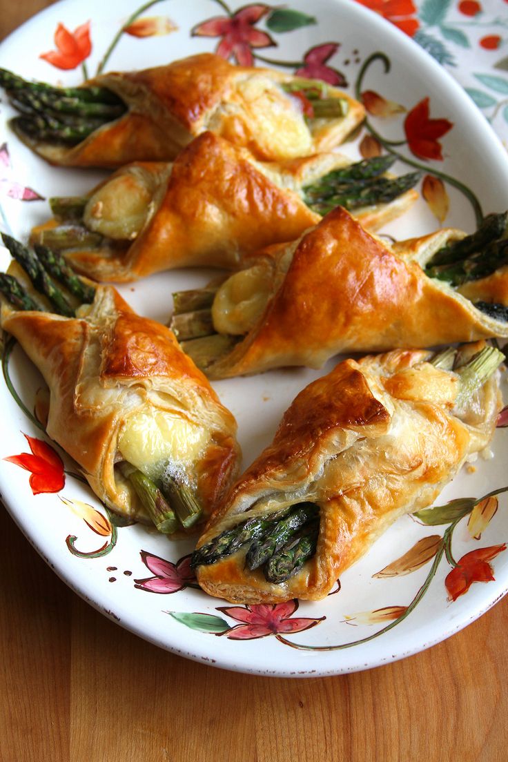 asparagus and cheese pastries on a floral plate