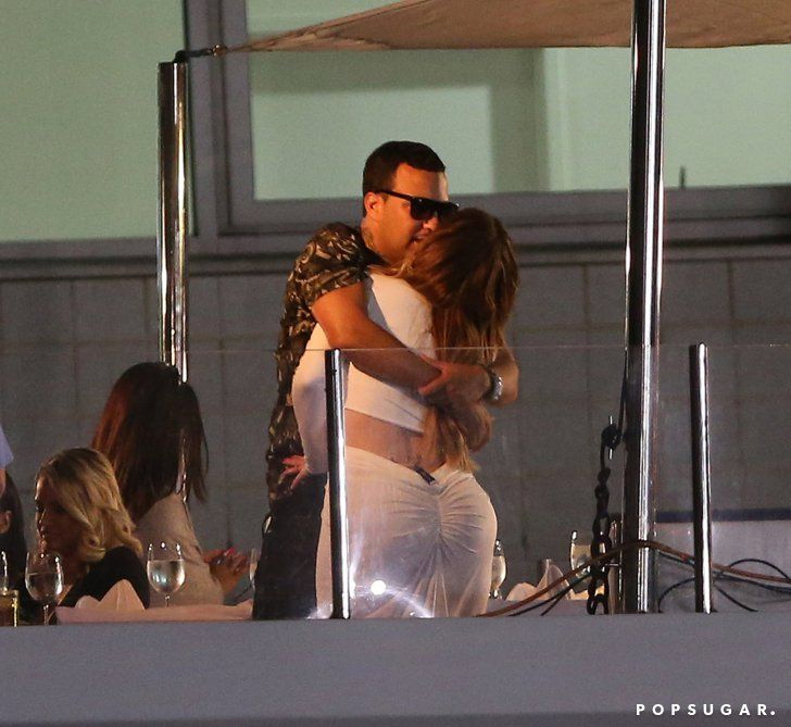 a man and woman kissing on the deck of a boat