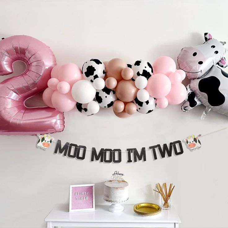 a cow themed birthday party with balloons and streamers for the number two balloon decoration