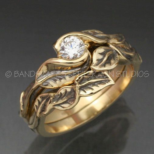 a gold ring with leaves and a diamond