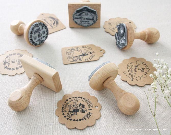 several rubber stamps are placed next to each other on a white tablecloth with flowers